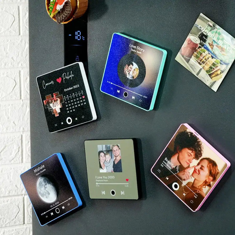 Colorful personalized music fridge magnets displaying custom album designs on a kitchen wall.