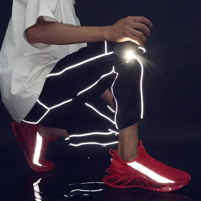 Men in red breathable sneakers with reflective details, styled in casual athletic wear.