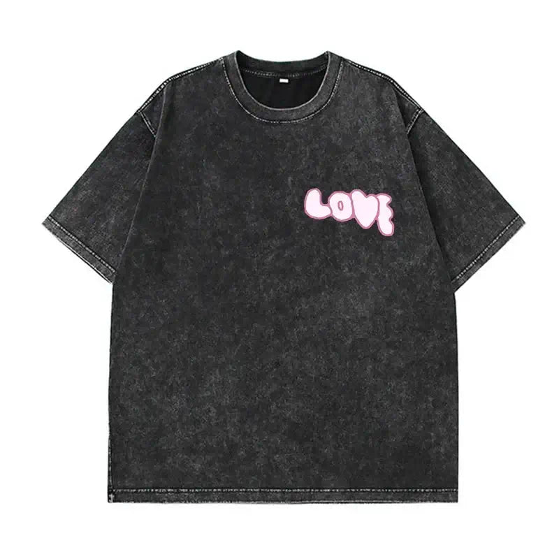 Oversized black vintage t-shirt with pink 'LOVE' graphic print for a casual and trendy look.