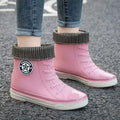 Pink high top rain boots with detachable cotton cover, stylish and waterproof footwear for women.