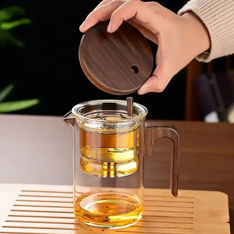 Heat-resistant glass teapot with stainless steel infuser and wooden lid, perfect for tea lovers.