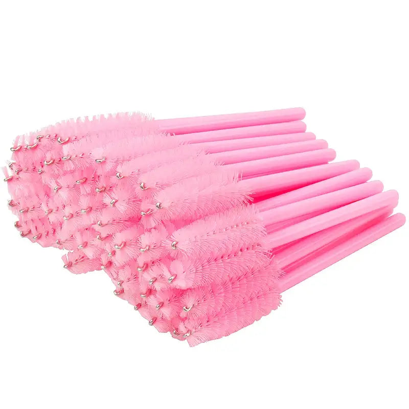 50 pink disposable eyelash brushes with plastic handles for makeup and lash extension applications.