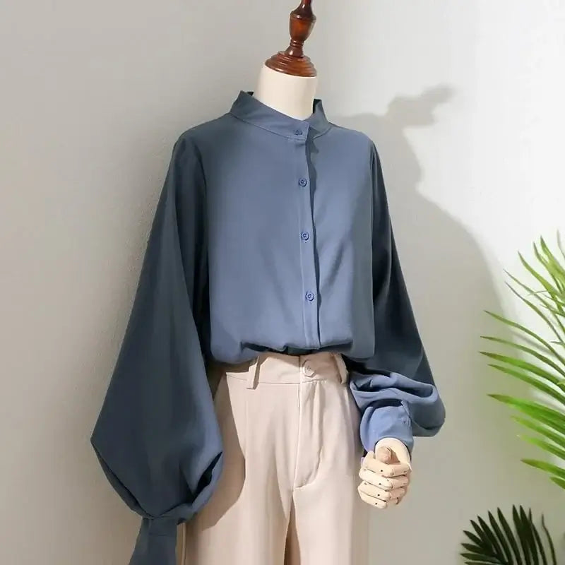 Women's blouse shirt in blue with long lantern sleeves and stand collar, perfect for casual spring and autumn wear.