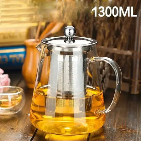 High quality 1300ml heat resistant glass teapot with stainless steel infuser and brewed tea.