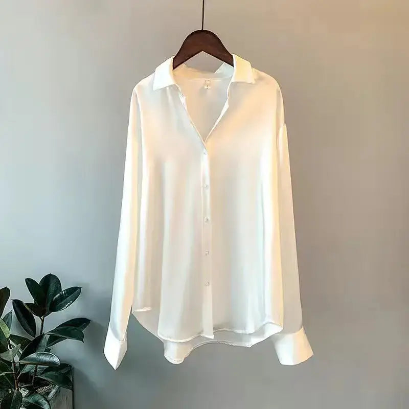 Elegant white long sleeve shirt on hanger, featuring a classic lapel and button-down design.