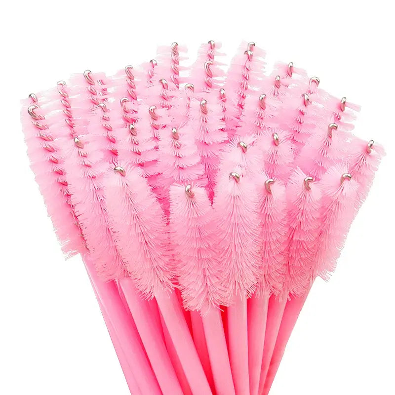 50 Pcs pink disposable eyelash brushes and eyebrow mascara wands for makeup application.