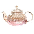 600ml striped pumpkin-shaped glass teapot with lid, featuring a clear body and pink liquid inside, ideal for herbal tea.