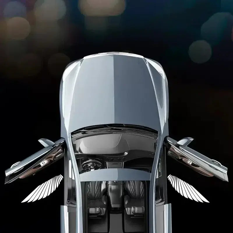 Car with angel wings LED door welcome light projecting shadows, showcasing stylish automotive accessories.