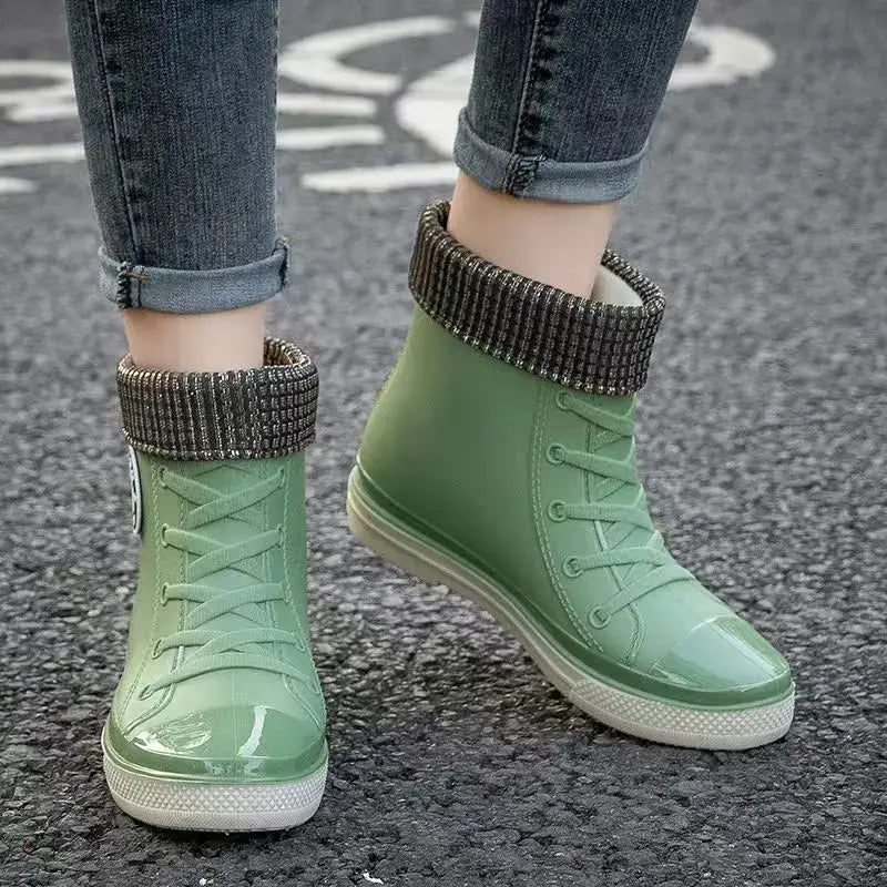 Green waterproof high top rain boots for women with detachable cotton cover and slip-on design.