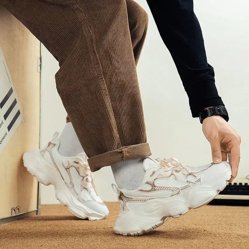 Man wearing breathable white sneakers with casual outfit, showcasing trendy and comfortable footwear for summer.