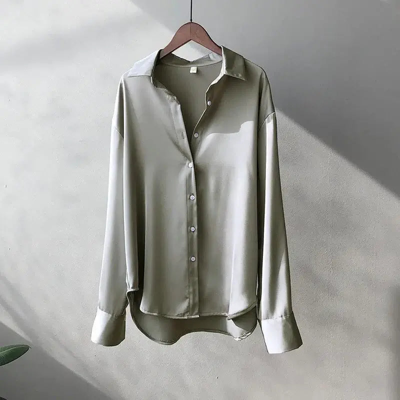 Elegant women's long sleeve satin shirt in soft green, featuring a lapel collar and button closure, perfect for casual wear.