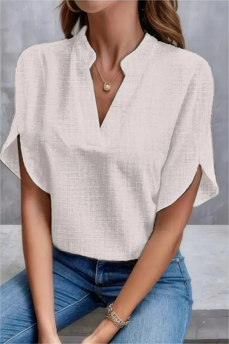 Elegant white casual blouse with V-neckline, perfect for summer office wear and everyday style.