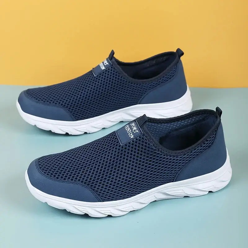 Breathable mesh slip-on sneakers for men, perfect for summer casual outdoor activities, in navy blue color.