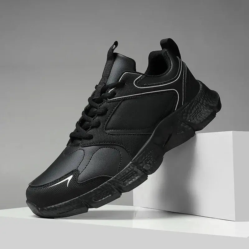 Men's breathable black sneakers with mixed materials and lace-up closure, ideal for casual wear and summer activities.