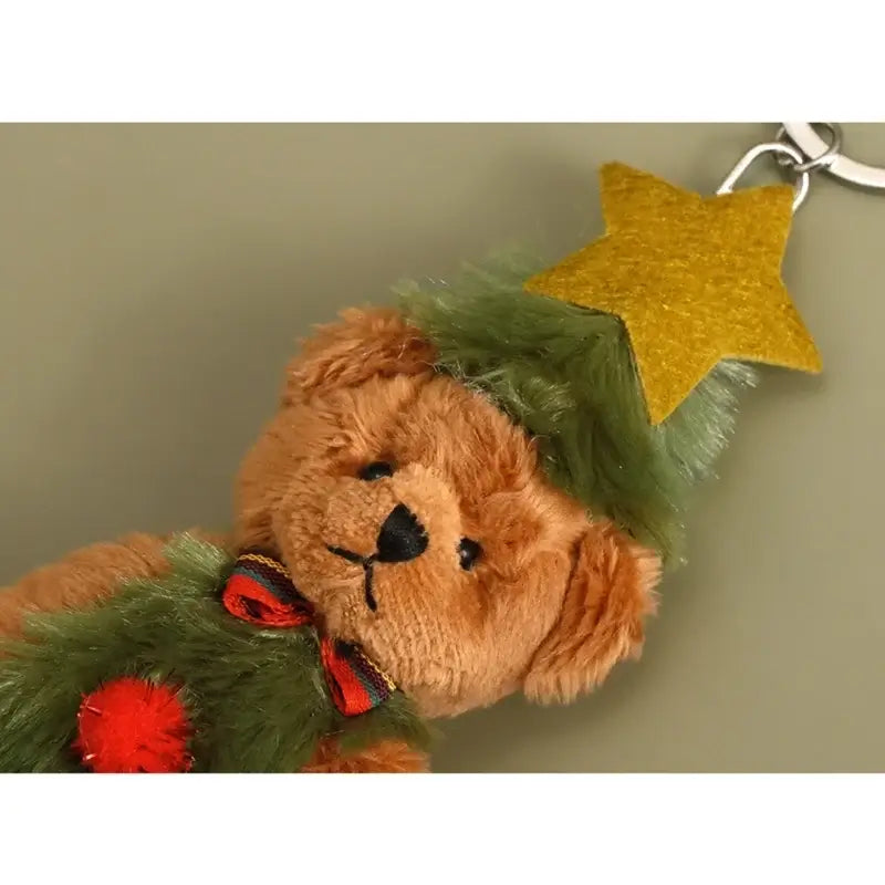 Cute Christmas bear keychain with a green hat and yellow star, perfect for festive decoration.