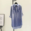 Women’s mid-length denim shirt dress with double pockets and rolled sleeves, perfect for all seasons.