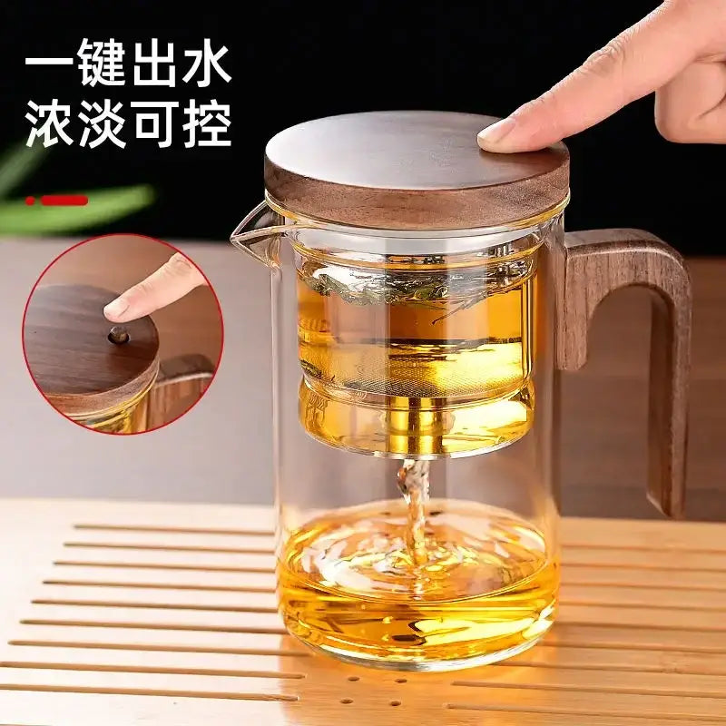 Heat-resistant glass teapot with wooden lid and stainless steel infuser, perfect for tea lovers.