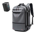 Large capacity men's travel backpack in gray with vacuum compression feature and accessories for business and hiking.