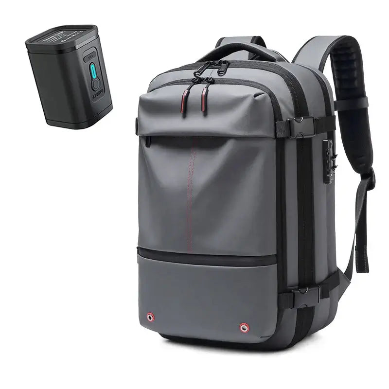 Large capacity men's travel backpack in gray with vacuum compression feature and accessories for business and hiking.