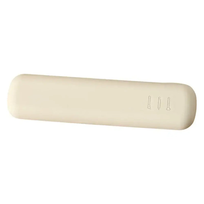 Portable silicone makeup brush holder case in soft cream color, designed for travel organization of cosmetic tools.