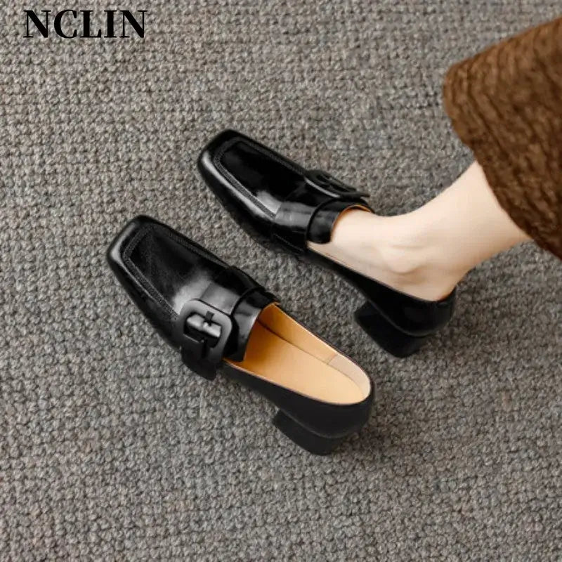 Chunky heel black loafers for women with square toe, genuine leather upper, belt buckle detail.