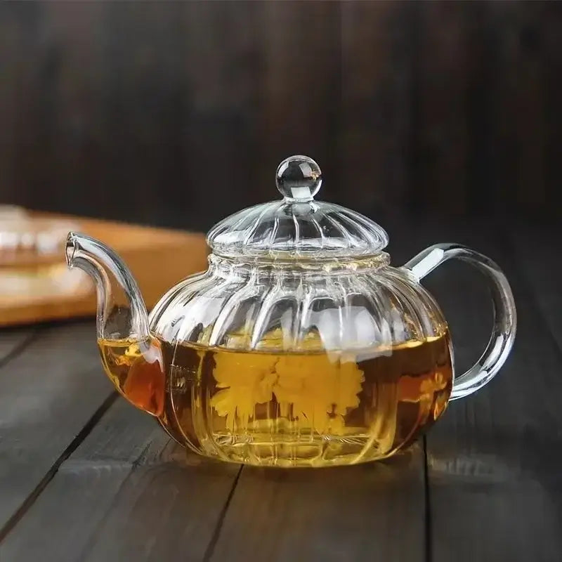 600ml striped pumpkin shape glass teapot with lid, filled with herbal tea, heat-resistant design for tea lovers.