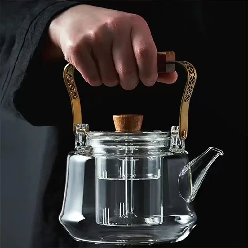 Japanese glass tea pot with copper wood handle, heat-resistant, ideal for brewing tea.