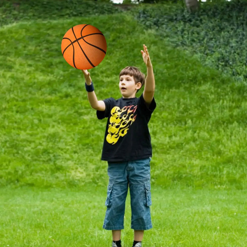 Boy practicing basketball skills outdoors in a grassy area, showcasing engaging play with a basketball.