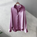 Elegant pink satin long sleeve button-up shirt on hanger, perfect for casual and chic spring styles.