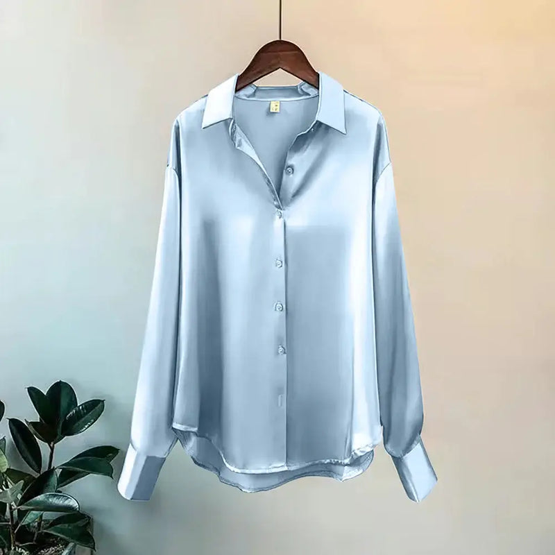 Elegant light blue satin long sleeve button-up shirt with a lapel collar, perfect for casual or semi-formal wear.