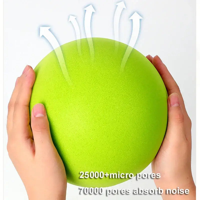 Green silent bouncy ball held in hands, featuring noise-absorbing micro pores for quiet play.