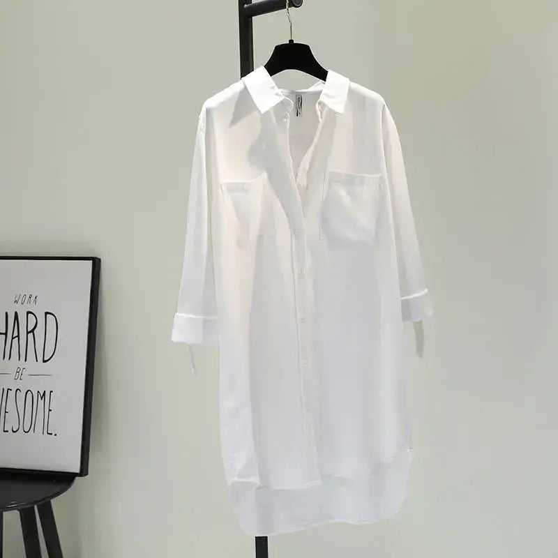 White mid-length shirt dress with rolled sleeves and double pockets, perfect for casual wear.