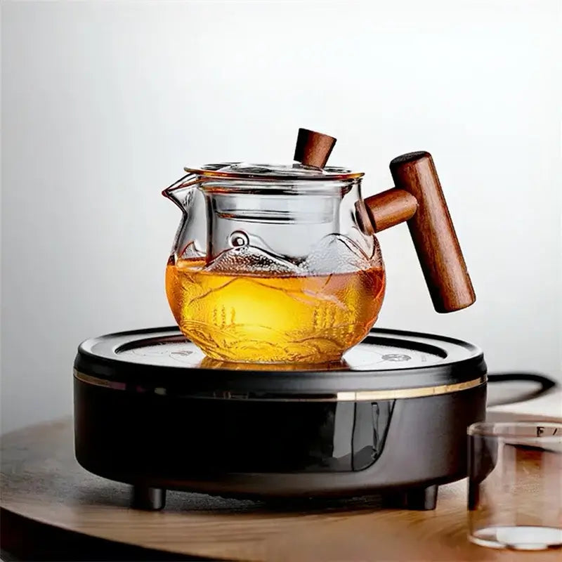 450ml heat resistant glass teapot with wooden handle on electric stove, brewing flower tea.